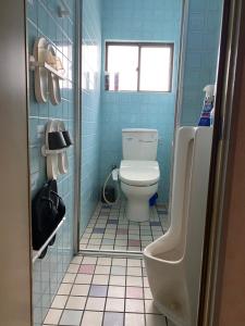 uma casa de banho azul com um WC e um lavatório em Casa del girasolカサデルヒラソル em Moriguchi
