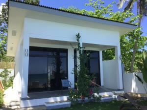 a small white house with a view of the ocean at BambooBeachVilla1 AC New OCEANFRONT POOL sunsetview garden kitchen SATELLITE STARLINK WI-FI in Dimiao