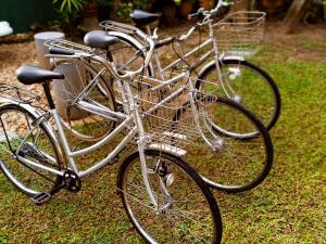 three bikes parked next to each other on the grass at Sun Set Sea Family House in Weligama