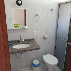 a bathroom with a sink and a toilet at Pousada Talismã in Florianópolis