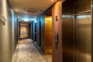 a corridor of an office building with a long hallway at The Ember Hotel in Bangkok