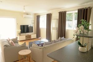 sala de estar con 2 sofás y TV en Family home in Prime location Melbourne, en Fern Tree Gully