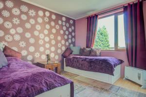 バンスコにあるGondola Flat Number 2の紫色のベッドルーム(ベッド2台、窓付)