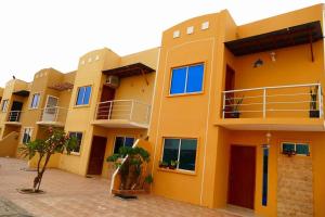 a large yellow building with a lot of windows at Luxury House 11 Private Beach 45Min Guayaquil in Salinas