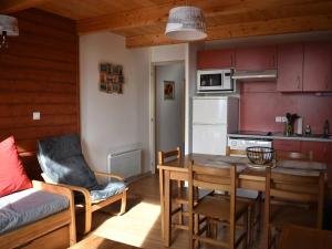 a kitchen and dining room with a table and a couch at Appartement Font-Romeu-Odeillo-Via, 3 pièces, 6 personnes - FR-1-580-77 in Font-Romeu-Odeillo-Via