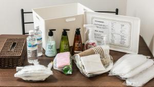 a table with bottles of detergents and a box at UCHI Living stay NAKAJIMA park in Sapporo