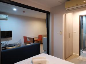 Habitación con mesa, sillas y ventana en 4 Floor - Centrio Condominium near Shopping Malls and Andamanda Water Park en Phuket