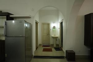 a bathroom with a refrigerator and a sink at Feel Like Home Rkbeach in Visakhapatnam