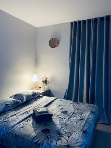 Un dormitorio con una cama y un reloj en la pared. en Angel's Nest, en Lo-oc