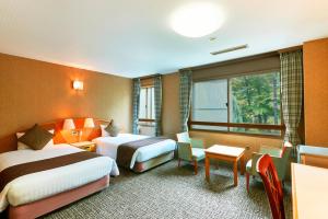 Giường trong phòng chung tại KAMENOI HOTEL Shiobara