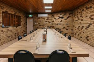 a large conference room with a long table and chairs at Abacus Motel in Mount Isa