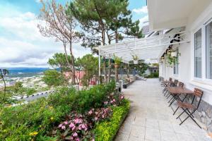 a patio with benches and flowers on a building at Villa Trung Nghĩa 31 in Da Lat