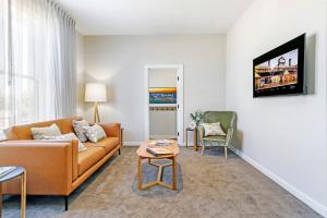 a living room with a couch and a table at The Tanunda Club Guest Suites in Tanunda