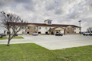 een groot gebouw met auto's geparkeerd op een parkeerplaats bij Cobblestone Inn & Suites - Fort Dodge in Fort Dodge