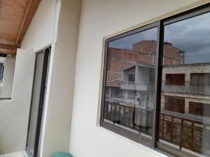 a window in a room with a view of a building at Amoblado centro de la Moda in Itagüí +5 photos