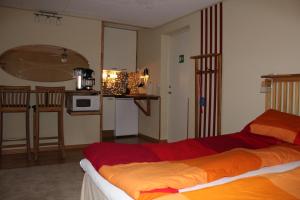 a hotel room with a bed and a kitchen at Hotel Borrby in Borrby