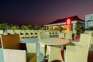 a patio with a table and chairs at night at Hotel Prism - A Boutique Hotel in Jorhāt