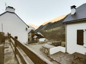 a group of buildings with mountains in the background at Maison Betpouey, 5 pièces, 8 personnes - FR-1-402-83 in Betpouey