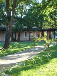 a house with trees in front of a driveway at Résidence Thibaud in Toulouse