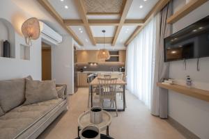 a living room with a couch and a table at Corallia villas near the beach in Plakias