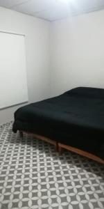 Una cama o camas en una habitación de Departamento DYD JUJUY