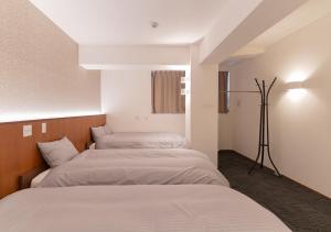 Ένα ή περισσότερα κρεβάτια σε δωμάτιο στο COCOSHUKU Nakano
