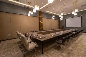 a large conference room with a long table and chairs at Shabran Wellbeing Resort in Pirǝbǝdil