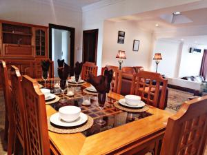 a dining room with a wooden table and chairs at Trumpetters Drift Game Farm in Grahamstown