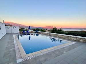 a swimming pool with a view of the mountains at Villa Thymari, panoramic sea views, Kokkino Horio in Kókkinon Khoríon