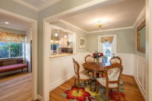 a dining room with a table and chairs at Charming Garden Cottage- steps to historic Old Town Half Moon Bay in Half Moon Bay