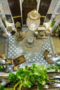 een kamer met een betegelde vloer en uitzicht op de omgeving bij Riad Rcif & Spa Originale in Fès