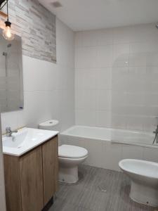 uma casa de banho com um lavatório, um WC e uma banheira em cuestas del arevalillo em Arévalo