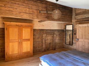 a bedroom with wooden walls and a bed in it at Chalet Brünig in Meiringen