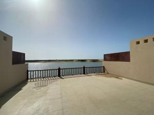 a balcony with a view of a body of water at Cove private one bedroom lagoon villa in Ras al Khaimah