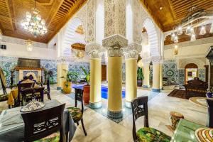 a large room with columns and tables and chairs at Riad Rcif & Spa Originale in Fez