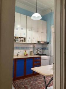 a kitchen with blue and white cabinets and a table at Üsküdar Villa in a Great Location in Istanbul