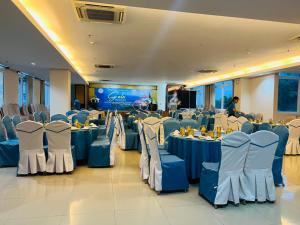 a banquet hall with blue and white tables and chairs at The Coast Hotel Vung Tau in Vung Tau