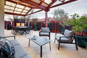 a patio with tables and chairs and a table at Bluewater Bungalow in Dunsborough