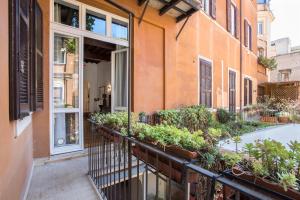 an apartment balcony with plants on a building at Casa Ameliotta Design in Rome