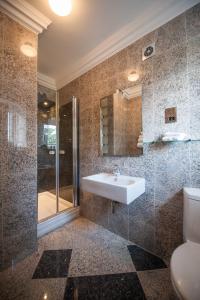 a bathroom with a sink and a shower at Dalston Hall in Carlisle