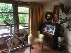 a room with a chair and a desk and a window at Near Amsterdam, The Hague, Leiden and North Sea in Warmond