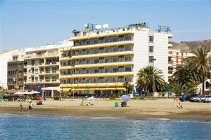 a hotel on the beach with people on the beach at Rincón Sol in Rincón de la Victoria