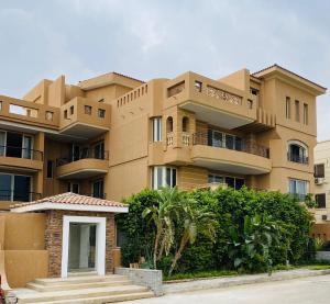 a large apartment building with a staircase in front of it at Maison 7 