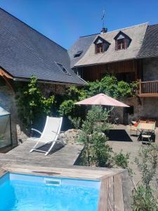 a house with a swimming pool in front of a house at Les Chatougoulis in Les Bordes-sur-Lez