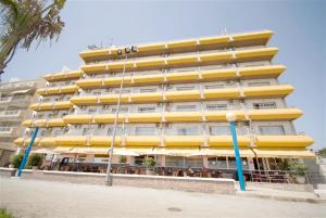 a large yellow building with a restaurant in front of it at Rincón Sol in Rincón de la Victoria