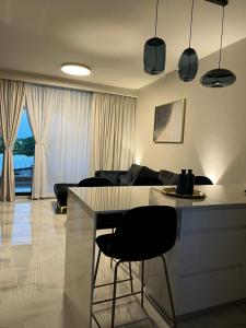a kitchen and living room with a counter and a table at Liz suite in Caesarea