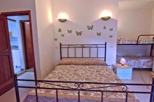 a bedroom with a bed and two bunk beds at Villa Very in Marina di Campo