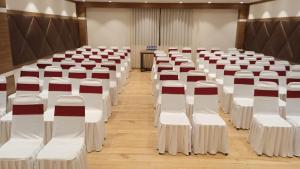 a row of white chairs in a room at Asian Buddha Hotel in Bhairāhawā