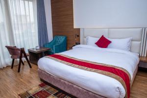 Ένα ή περισσότερα κρεβάτια σε δωμάτιο στο Asian Buddha Hotel