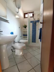 a bathroom with a toilet and a sink and a shower at SARDEGNA in Torre Dei Corsari